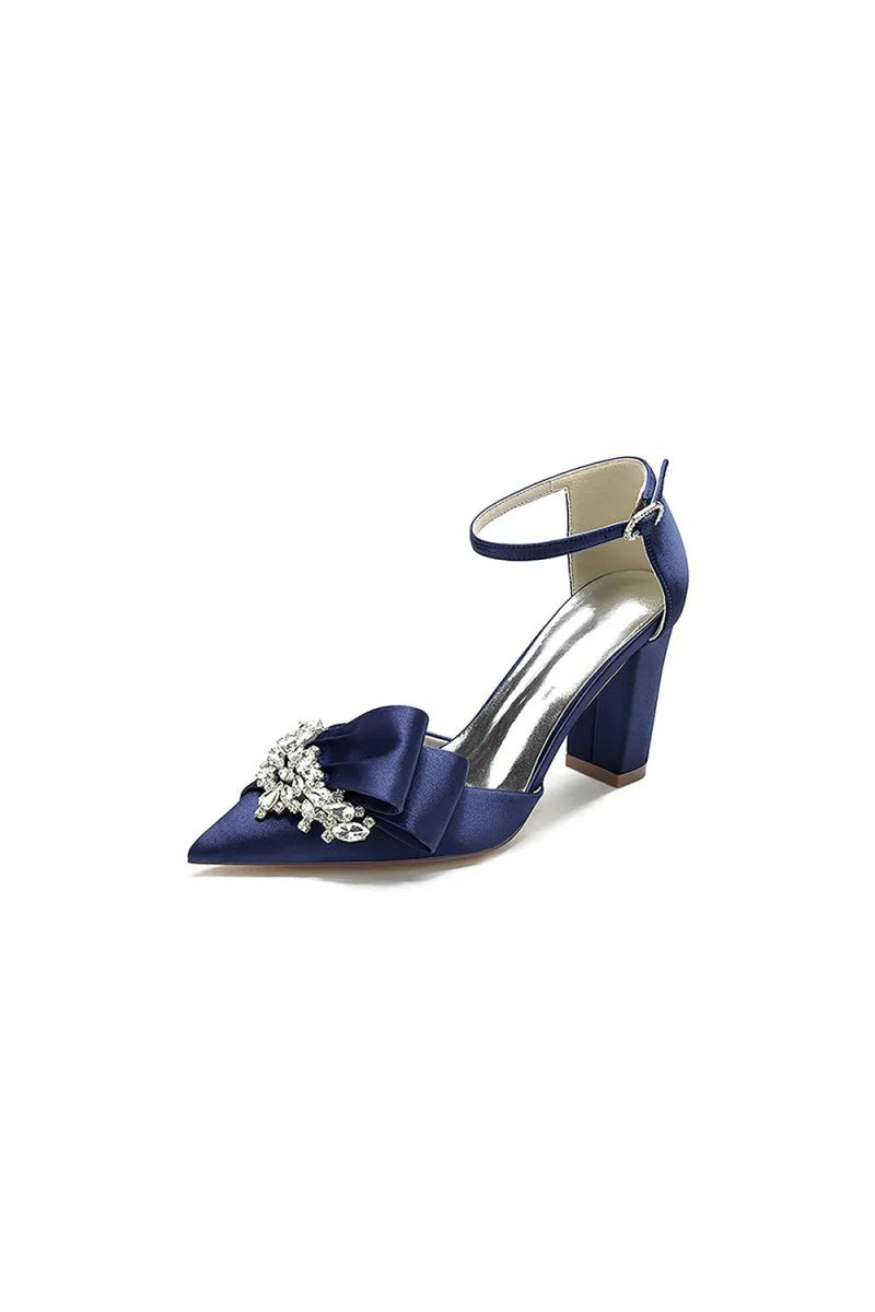 White Satin Heels Featuring a Large Decorative Bow and Metallic Heel